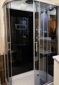 a shower with a glass door in a bathroom at Spacious 3BD Flat with Large Terrace & Sea View in Varna City