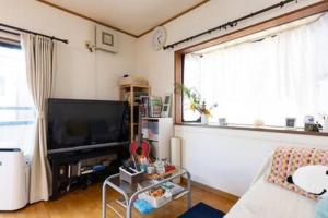 a living room with a large window and a television at Noriko's Home - Vacation STAY 8643 in Kawasaki