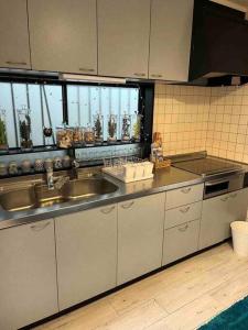 a kitchen with a sink and a counter top at 民宿　setouchi in Takamatsu