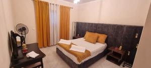 a bedroom with a bed with a wooden headboard at Beach House 29 in Portimão