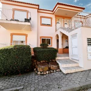 a house with bushes and a walkway in front of it at Beach House 29 in Portimão