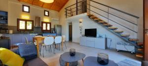 a kitchen and a living room with a staircase at Kastania Villas- Villa K3 in Pouríon
