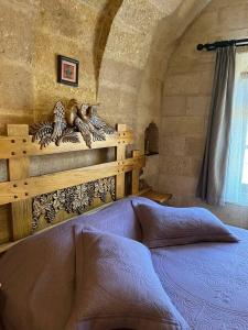 a bedroom with a bed and shelves in a room at Kayhan Cave Villa in Urgup