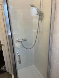a shower with a glass door in a bathroom at Modern Studio with Free Parking near sea-station-shops in Portslade