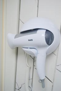 a hair dryer hanging on a wall at Karhal Hotel in Edirne