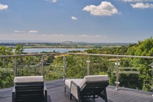 a balcony with two chairs and a view of a river at Reservoir View in Cheddar +22 photos