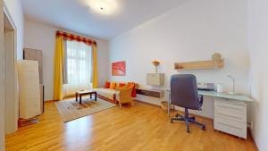 a living room with a desk and a chair at Central Apartmany Biela street in Bratislava