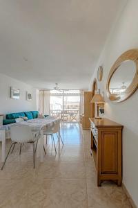 a living room with a table and a dining room at Tenerifeopenhome bright penthouse on the beach Los Cristianos in Arona