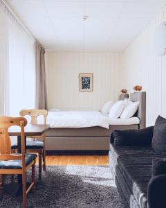a hotel room with a bed and a couch at Lofsdalens Fjällhotell & Hotellbyns lägenheter in Lofsdalen