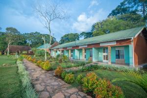 a row of houses with a garden in front at Mirembe Resort Beach Hotel Ssese in Kalangala