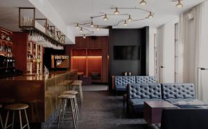 a bar with blue couches and a counter in a restaurant at Boutique Hotel Danmark in Copenhagen