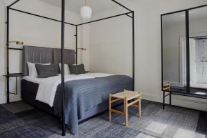a bedroom with a large bed and a table at Hotel Danmark by Brøchner Hotels in Copenhagen