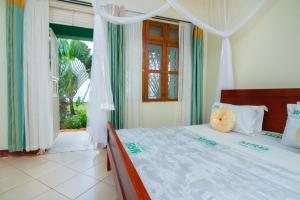 a bedroom with a bed and a window at Mirembe Resort Beach Hotel Ssese in Kalangala +127 photos