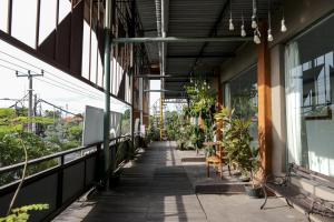 an empty corridor of a building with plants at RedDoorz Plus at Sunrise Hotel Sanur in Sanur