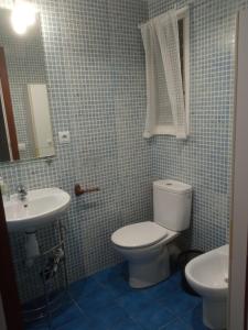 a bathroom with a toilet and a sink at Cal Turuta in Vilanova i la Geltrú