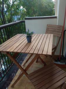 uma mesa de madeira e um vaso de plantas numa varanda em Cal Turuta em Vilanova i la Geltrú