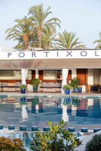 a hotel with a swimming pool in front of it at Portixol Hotel & Restaurant in Palma de Mallorca