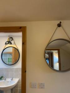 a bathroom with a mirror and a sink at Orkney Staycations - Orcadale in Orkney