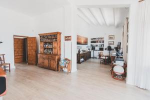 a living room with wooden furniture and a dining room at Casa del Canto, Calapanizo in Cuevas del Almanzora