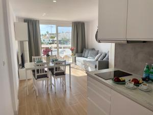 a kitchen and living room with a table and chairs at Malibu Park 3078 - Ocean View Studio in Adeje