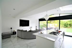 a kitchen and living room with a couch and a stove at Stunning executive style property. in Crosby