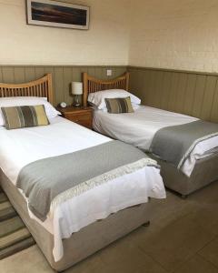 two beds sitting next to each other in a room at Hyde Mill in Luton +14 photos