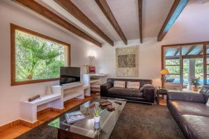 a living room with a couch and a table at Villa Mireia in Pollença