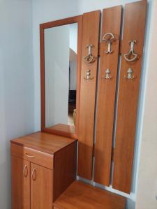 a dressing room with a mirror and wooden cabinets at Plava Vila Beach Apartments Sveti Stefan in Sveti Stefan