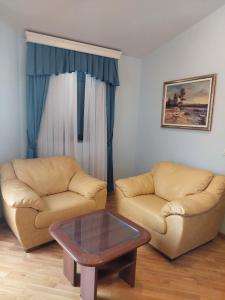 a living room with two couches and a coffee table at Plava Vila Beach Apartments Sveti Stefan in Sveti Stefan