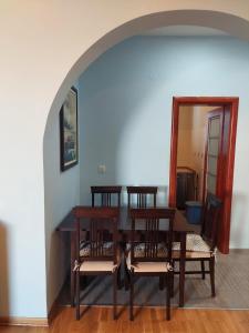 a dining room with a table and chairs and a mirror at Plava Vila Beach Apartments Sveti Stefan in Sveti Stefan