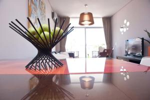 a dining table with a vase of green bananas on it at Apartment Santa Fe Plaza in Buenos Aires