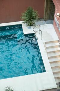 a swimming pool with stairs and blue water at The Dean Galway in Galway