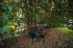 una mesa y sillas sentadas en el bosque en Tents resort Posestvo SONČNI RAJ, en Maribor
