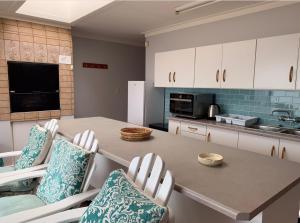 a kitchen with a table with chairs and a sink at Seaview at it’s best in Hentiesbaai