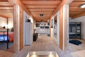 a bedroom and a living room with wooden ceilings at Im traditionellen Bauernhaus in Nesselwang