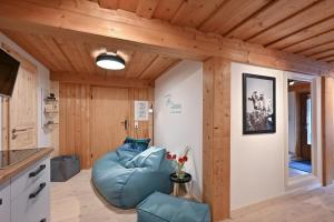 a living room with a blue bean bag chair at Im traditionellen Bauernhaus in Nesselwang