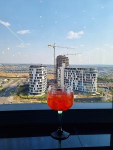 a wine glass sitting on a table in front of a window at Ellipse Apartment in Midrand