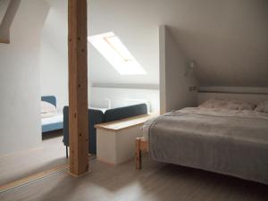 a bedroom with a bed and a desk and a window at Měšťanský dům Rožmberk 31 in Rožmberk nad Vltavou