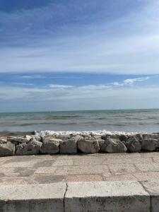 a row of rocks next to the ocean at Villa AMARE in Caorle