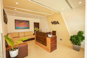 an office lobby with a reception desk and potted plants at The Windy Mist Resort Munnar in Chinnakanal