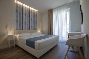 Posteľ alebo postele v izbe v ubytovaní Luxmarì Hotel & Spa