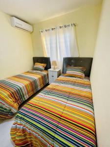 Postel nebo postele na pokoji v ubytování Cozy Apart. para Familias grandes/15min Aeropuerto