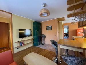 a kitchen with a table and chairs and a television at "Summer" apartment in Viljandi