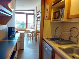 a kitchen with a sink and a counter top at Studio Les Arcs 1800, 1 pièce, 4 personnes - FR-1-411-644 in Arc 1800