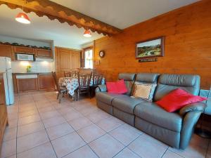 a living room with a couch and a kitchen at Appartement Samoëns, 3 pièces, 4 personnes - FR-1-624-63 in Samoëns