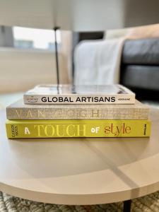 three books sitting on top of a coffee table at Apartment by Spitalfields & Liverpool Street Station in London
