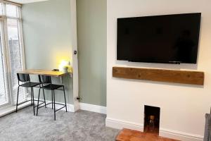a living room with a flat screen tv on a wall at Incredible house for Work teams & Holiday stays in Cleethorpes