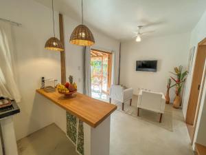 a kitchen with a table with a bowl of fruit on it at Villa Milagre in Trancoso
