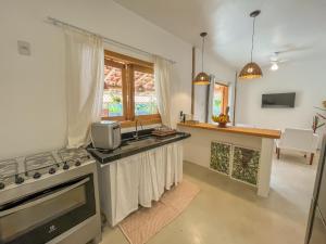 a kitchen with a sink and a stove at Villa Milagre in Trancoso