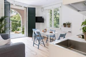 a kitchen and living room with a table and chairs at Ca' de Ma in Diano Marina
